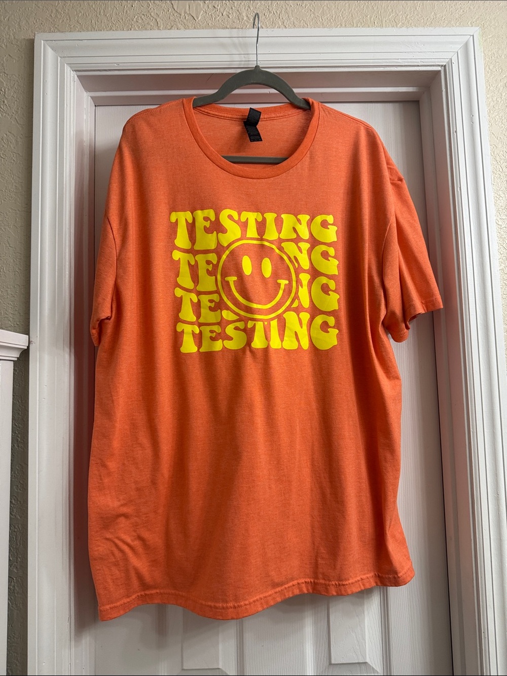 Orange Graphic Tee with Yellow Smiley 'TESTING' Print